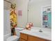 Bathroom with a single sink vanity, framed mirror and unique decorative touches at 770 Huiet Dr, Mcdonough, GA 30252
