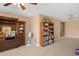 Spacious bonus room featuring neutral carpeting, ceiling fan and multiple display cabinets at 770 Huiet Dr, Mcdonough, GA 30252