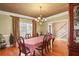 Formal dining room with wood floors, chandelier, and natural light from a large window at 770 Huiet Dr, Mcdonough, GA 30252