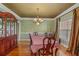 Elegant dining room with hardwood floors, chandelier, and ornate china cabinet at 770 Huiet Dr, Mcdonough, GA 30252