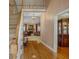 Inviting foyer with hardwood floors, staircase, and view of living room with fireplace at 770 Huiet Dr, Mcdonough, GA 30252