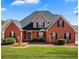 Charming red brick home with manicured landscaping and a walkway to the front entrance at 770 Huiet Dr, Mcdonough, GA 30252