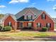 Charming red brick home with manicured landscaping and a walkway to the front entrance at 770 Huiet Dr, Mcdonough, GA 30252