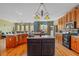 Kitchen features dark wood cabinets, pendant lights, and stainless-steel appliances at 770 Huiet Dr, Mcdonough, GA 30252