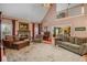Cozy living room featuring a fireplace, vaulted ceiling, and hardwood floors with open access to the dining room at 770 Huiet Dr, Mcdonough, GA 30252