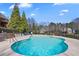 Refreshing pool with ample space, landscaped backyard and surrounding trees at 770 Huiet Dr, Mcdonough, GA 30252