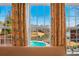Picturesque view through the windows overlooking a pool and serene lake at 770 Huiet Dr, Mcdonough, GA 30252