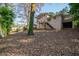 Large backyard with mature trees, a brick home, and a walkout basement at 2717 Hedgewood Nw Dr, Atlanta, GA 30311