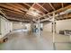 Unfinished basement with concrete floor, exposed ductwork, and a partially finished wall at 2717 Hedgewood Nw Dr, Atlanta, GA 30311