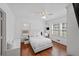 Cozy bedroom with hardwood floors, two windows, and a comfortable bed with white linens at 2717 Hedgewood Nw Dr, Atlanta, GA 30311