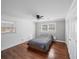 Serene bedroom with hardwood floors, two windows, and a comfortable bed with a gray comforter at 2717 Hedgewood Nw Dr, Atlanta, GA 30311