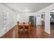 Bright dining room featuring hardwood floors, complemented by a stainless steel refrigerator and access to a modern kitchen at 2717 Hedgewood Nw Dr, Atlanta, GA 30311