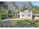 Inviting two-story home with covered porch and carport, nestled on a lush, treed lot, offering both charm and convenience at 2717 Hedgewood Nw Dr, Atlanta, GA 30311