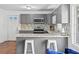 Stylish kitchen with granite countertops, mosaic backsplash, stainless steel appliances, and bar seating for casual dining at 2717 Hedgewood Nw Dr, Atlanta, GA 30311