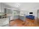 Open living space seamlessly connects the kitchen, living area with a modern blue couch and a staircase at 2717 Hedgewood Nw Dr, Atlanta, GA 30311