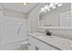 Bathroom features new shower and tub, granite countertops and modern lighting at 2828 Webb Bridge Rd, Alpharetta, GA 30009
