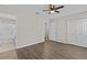 Large bedroom features wood-look floors, ceiling fan, ensuite bathroom, and closet at 2828 Webb Bridge Rd, Alpharetta, GA 30009