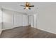 Spacious bedroom with ceiling fan, wood-look flooring, closet, and neutral paint at 2828 Webb Bridge Rd, Alpharetta, GA 30009