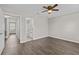 Large bedroom features wood-look floors, ceiling fan, and ensuite bathroom at 2828 Webb Bridge Rd, Alpharetta, GA 30009