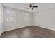 Bright bedroom with two windows, wood-look floors, and a ceiling fan at 2828 Webb Bridge Rd, Alpharetta, GA 30009