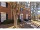 Brick townhome with well-maintained landscaping and walkway at 2828 Webb Bridge Rd, Alpharetta, GA 30009