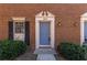 Close up of a charming brick townhome with blue front door at 2828 Webb Bridge Rd, Alpharetta, GA 30009