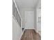 Hallway with hardwood floors and a view of the front door and kitchen at 2828 Webb Bridge Rd, Alpharetta, GA 30009
