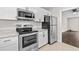 Well-lit kitchen features stainless steel appliances, white cabinets, and granite countertops at 2828 Webb Bridge Rd, Alpharetta, GA 30009
