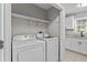 Bright laundry room with washer and dryer hookups, plus extra cabinets and countertop space at 2828 Webb Bridge Rd, Alpharetta, GA 30009