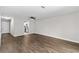 Open-concept living area featuring hardwood floors and a view of the kitchen at 2828 Webb Bridge Rd, Alpharetta, GA 30009