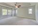 Spacious main bedroom with ceiling fan, tray ceiling, and large windows at 4040 Andover Cir, Mcdonough, GA 30252