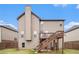 Rear exterior of home with wood deck and stairs, siding, and lawn at 949 Nevis Way, Mcdonough, GA 30253