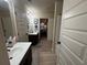 Bathroom featuring double sinks with dark wood cabinets, and a view of the bedroom at 949 Nevis Way, Mcdonough, GA 30253