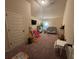 Spacious bedroom features a TV, toys, play slide, baby crib, and light from a window at 949 Nevis Way, Mcdonough, GA 30253