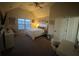 Light-filled bedroom features a sloped ceiling, ceiling fan, bed, art, and a white desk at 949 Nevis Way, Mcdonough, GA 30253