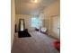 Spacious room with carpet flooring, a window, black rug, and a door at 949 Nevis Way, Mcdonough, GA 30253