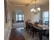 Formal dining room with coffered ceilings, chandelier, and arched doorway at 949 Nevis Way, Mcdonough, GA 30253