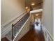 Inviting foyer with hardwood floors, staircase with iron spindles, and dining room view at 949 Nevis Way, Mcdonough, GA 30253