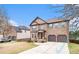 Lovely brick home with two-car garage, landscaped front yard and inviting red front door at 949 Nevis Way, Mcdonough, GA 30253