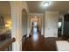 Hallway leading to dining room and foyer featuring hardwood flooring and arched doorways at 949 Nevis Way, Mcdonough, GA 30253
