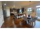 Open concept kitchen features stainless steel appliances, granite countertops, breakfast bar, and hardwood floors at 949 Nevis Way, Mcdonough, GA 30253
