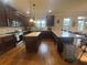 Spacious kitchen features granite countertops, stainless steel appliances, hardwood floors, and island with breakfast bar at 949 Nevis Way, Mcdonough, GA 30253