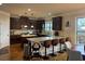 Bright and spacious kitchen featuring stainless steel appliances, granite countertops, breakfast bar seating, and hardwood floors at 949 Nevis Way, Mcdonough, GA 30253