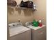 Laundry room featuring a wire rack, white washer and dryer, cleaning supplies, and wall paint at 949 Nevis Way, Mcdonough, GA 30253