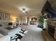 Cozy living room features fireplace, plush seating, and large television at 949 Nevis Way, Mcdonough, GA 30253