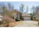 Charming two-story home with a well-manicured lawn, blooming bushes, and a two-car garage at 135 Belmont Trce, Atlanta, GA 30328