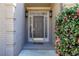 Elegant front door featuring decorative glass and a blooming bush, set in a painted brick facade at 135 Belmont Trce, Atlanta, GA 30328