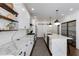 Bright kitchen features white cabinets, marble countertops, and modern lighting fixtures at 135 Belmont Trce, Atlanta, GA 30328