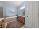 Bright bathroom with a soaking tub, granite counters, and a separate shower at 5002 Davenport Pl, Roswell, GA 30075