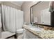 Well-lit bathroom with granite countertops, white cabinets, and shower and tub combination at 5002 Davenport Pl, Roswell, GA 30075